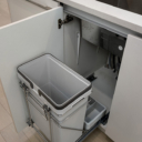 Kitchen island pull-out waste bin feature at Avenue 33 by Vertex Developments, showcasing integrated kitchen design for convenience and functionality.